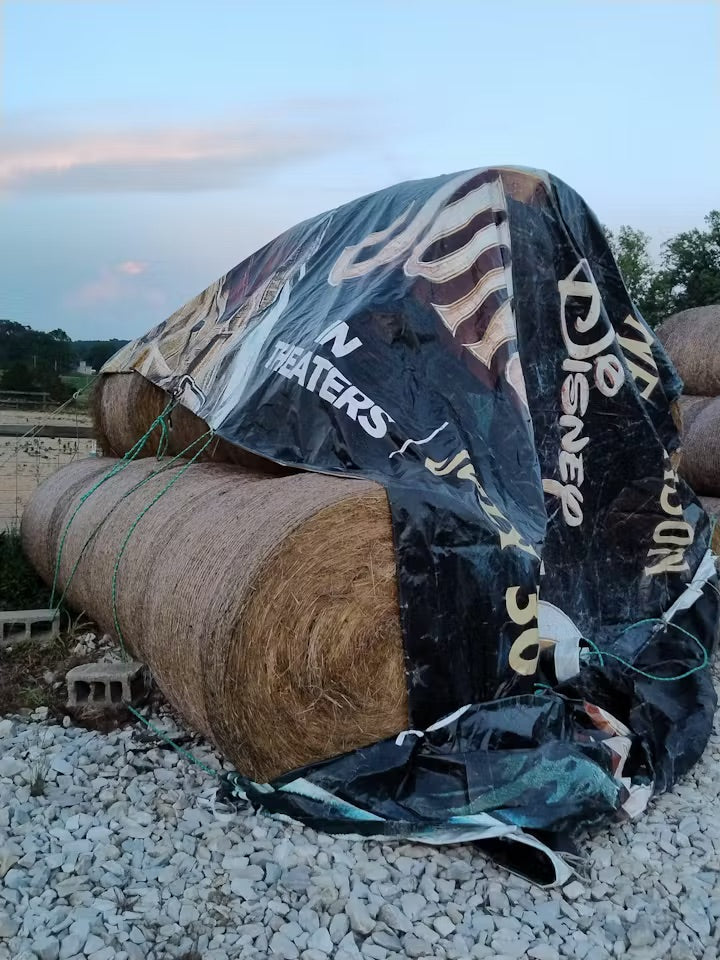 Weather-resistant tarp used to protect a motorcycle in a suburban driveway